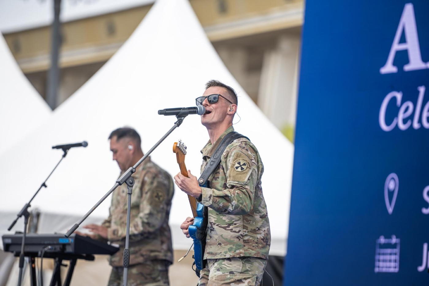 A band in United States service uniform playing on the America Days stage
