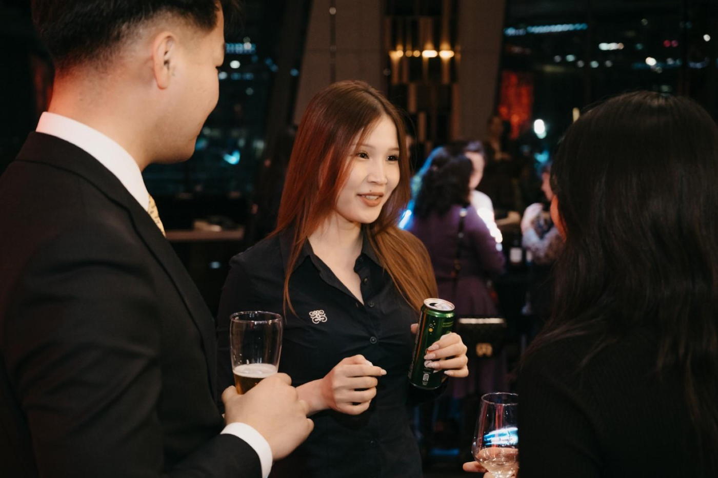 A member with a drink at an evening reception