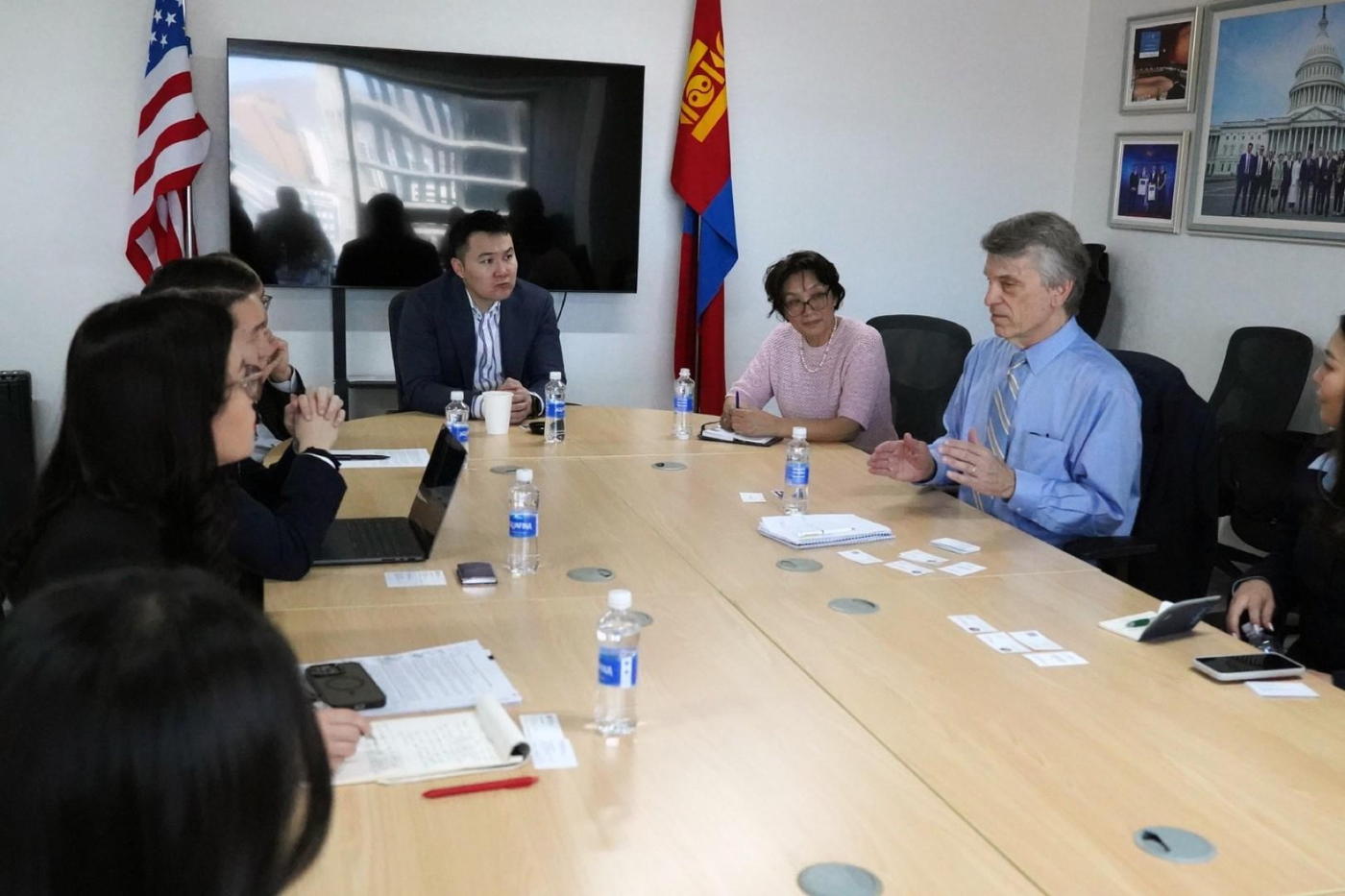 A boardroom discussion under the American and Mongolian flags