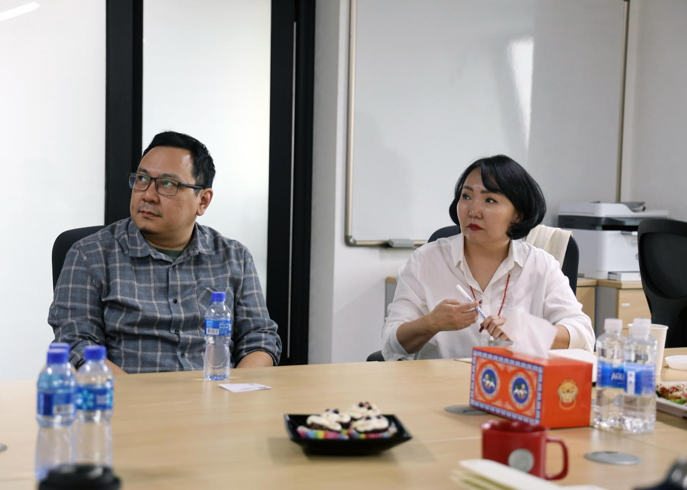 Two people at a seminar table